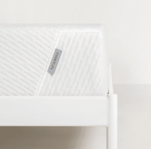 Tuft & Needle Mattress Review 2021 - Should You Buy One? 2 Original Tuft and Needle mattress; close-up of the bed's corner against a blank background.