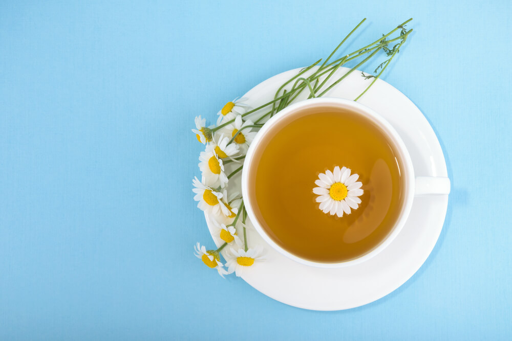 Cup of tea and chamomiles