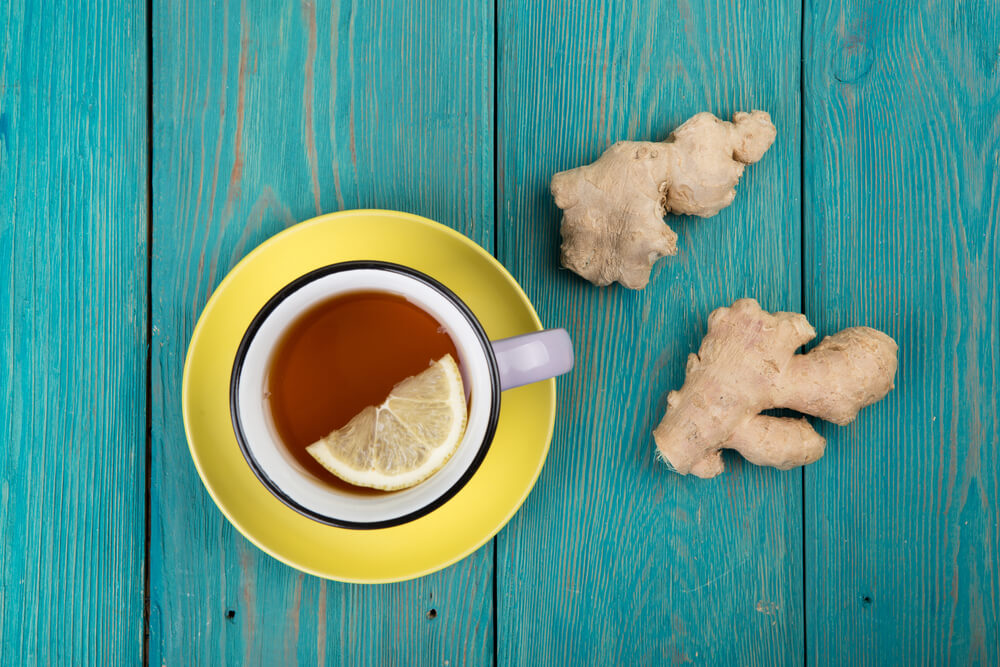 Ginger tea for sleep in a vintage cup on wooden background