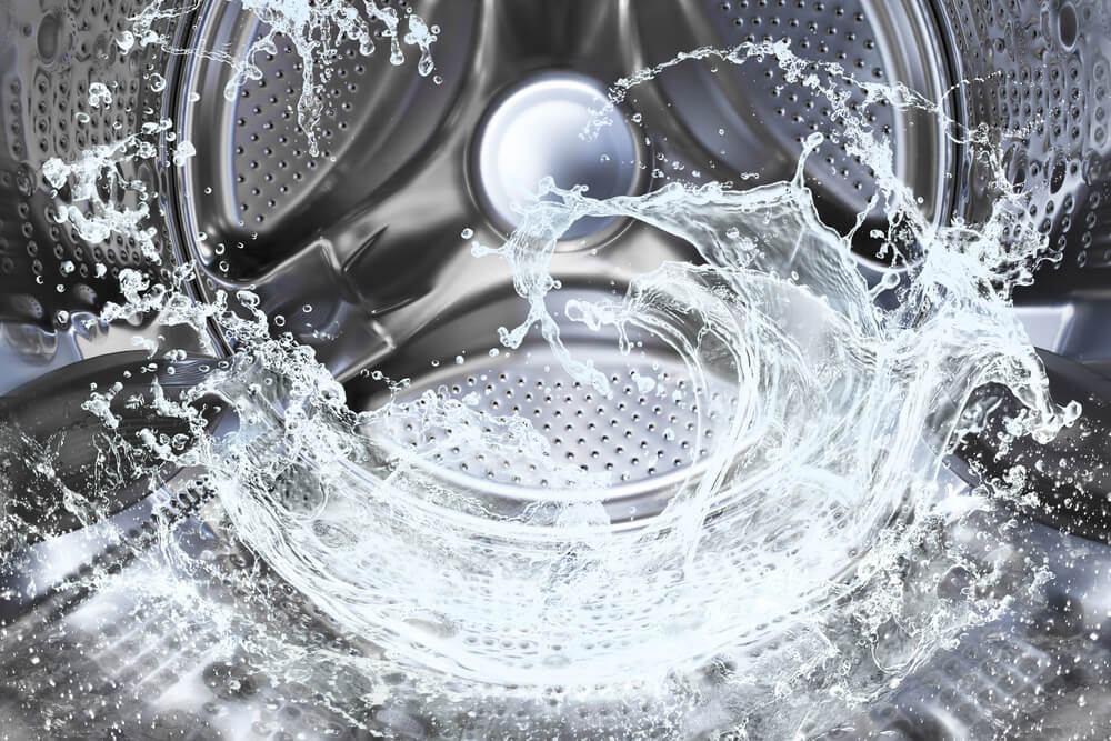 The inside metal barrel of a washing machine filled with water.
